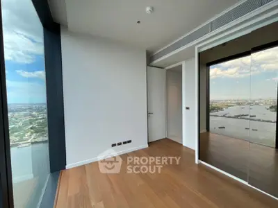 Stunning high-rise corner unit with breathtaking city and river views, featuring floor-to-ceiling windows and elegant hardwood floors.
