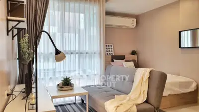 Modern studio apartment with cozy living area and natural light