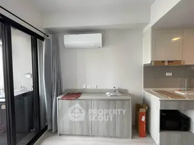 Modern kitchen with sleek cabinetry and air conditioning in a bright apartment