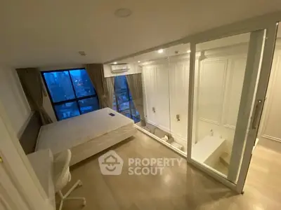 Luxurious bedroom with city view and glass-walled bathroom