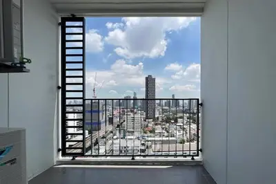 Stunning city view from a modern balcony in a high-rise apartment.