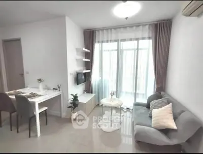 Modern living room with cozy seating and dining area, featuring natural light and stylish decor.