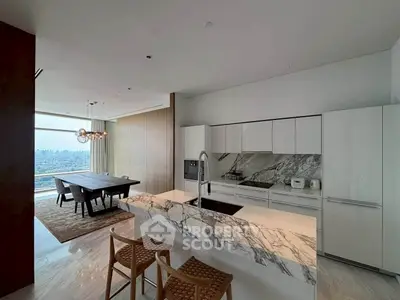 Luxurious modern kitchen with marble island and stunning city view, perfect for entertaining.