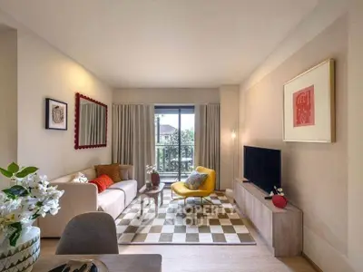 Stylish living room with modern decor, cozy seating, and natural light from large window.