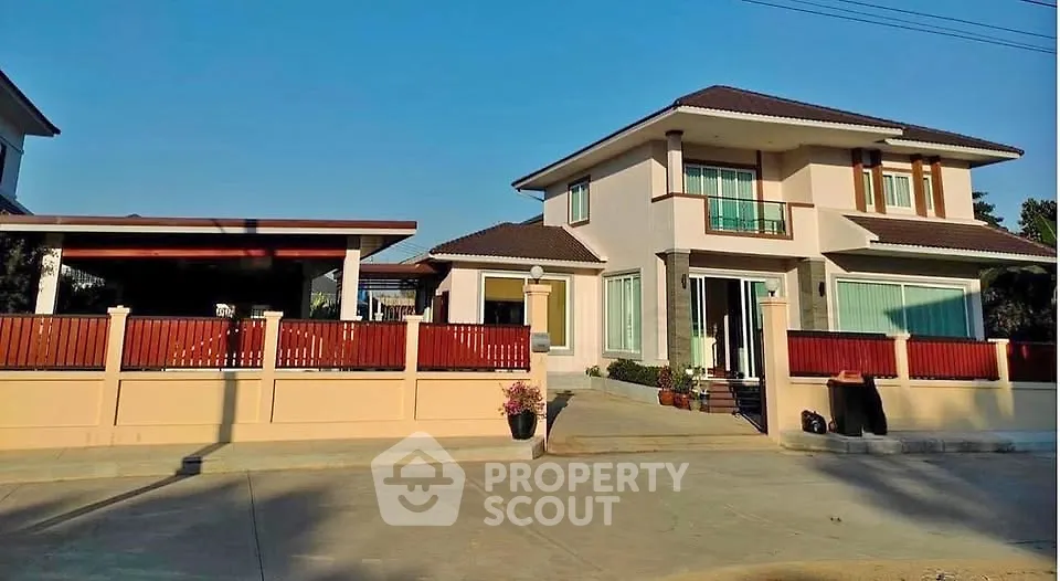 Stunning modern two-story house with spacious driveway and elegant fencing.