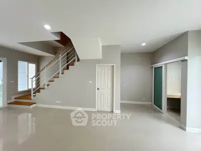Spacious modern living room with staircase and sleek design