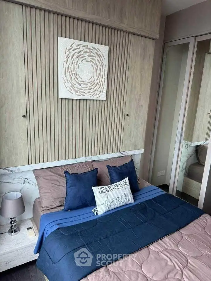 Modern bedroom with stylish decor and cozy bedding in a contemporary apartment.