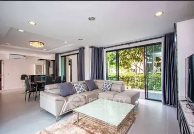 Spacious modern living room with large windows and elegant decor