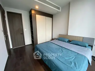 Modern bedroom with sleek design and cozy ambiance, featuring a spacious bed and stylish wardrobe.
