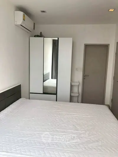 Modern bedroom with sleek wardrobe and air conditioning unit
