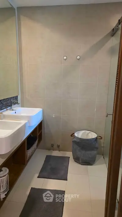 Modern bathroom with dual sinks and stylish decor in a contemporary home.