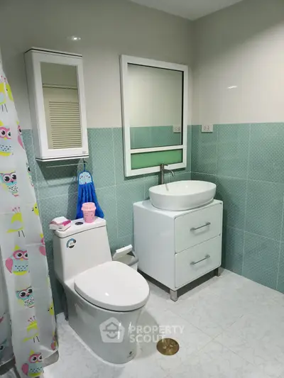 Modern bathroom with stylish sink and owl-themed shower curtain