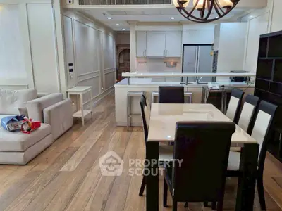 Spacious open-plan living and dining area with modern kitchen and elegant furnishings.