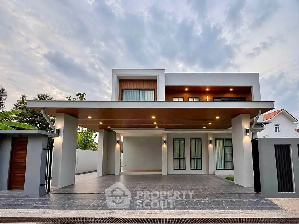 Modern two-story house with spacious driveway and sleek architectural design.