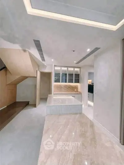 Modern interior with sleek design and open layout, featuring elegant lighting and polished flooring.