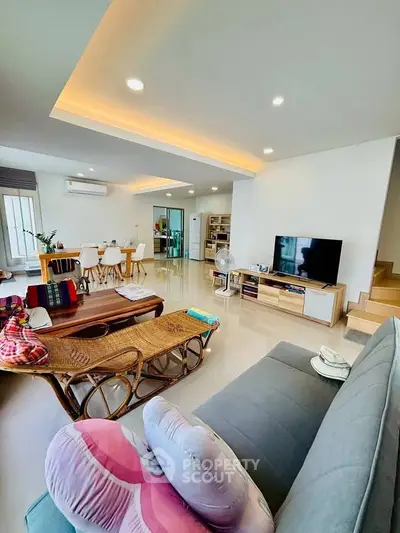 Spacious modern living room with stylish decor and open layout, perfect for family gatherings.
