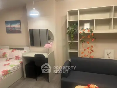 Charming studio apartment with modern decor, featuring a cozy bed, stylish sofa, and functional workspace.