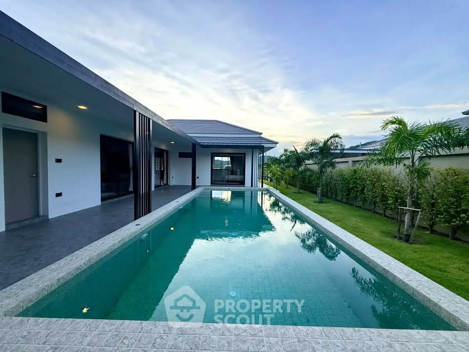 Luxurious modern home with sleek pool and lush garden