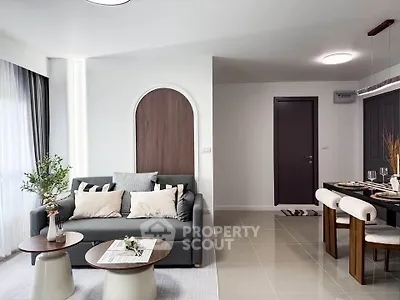 Modern living room with stylish decor and dining area in open layout apartment.