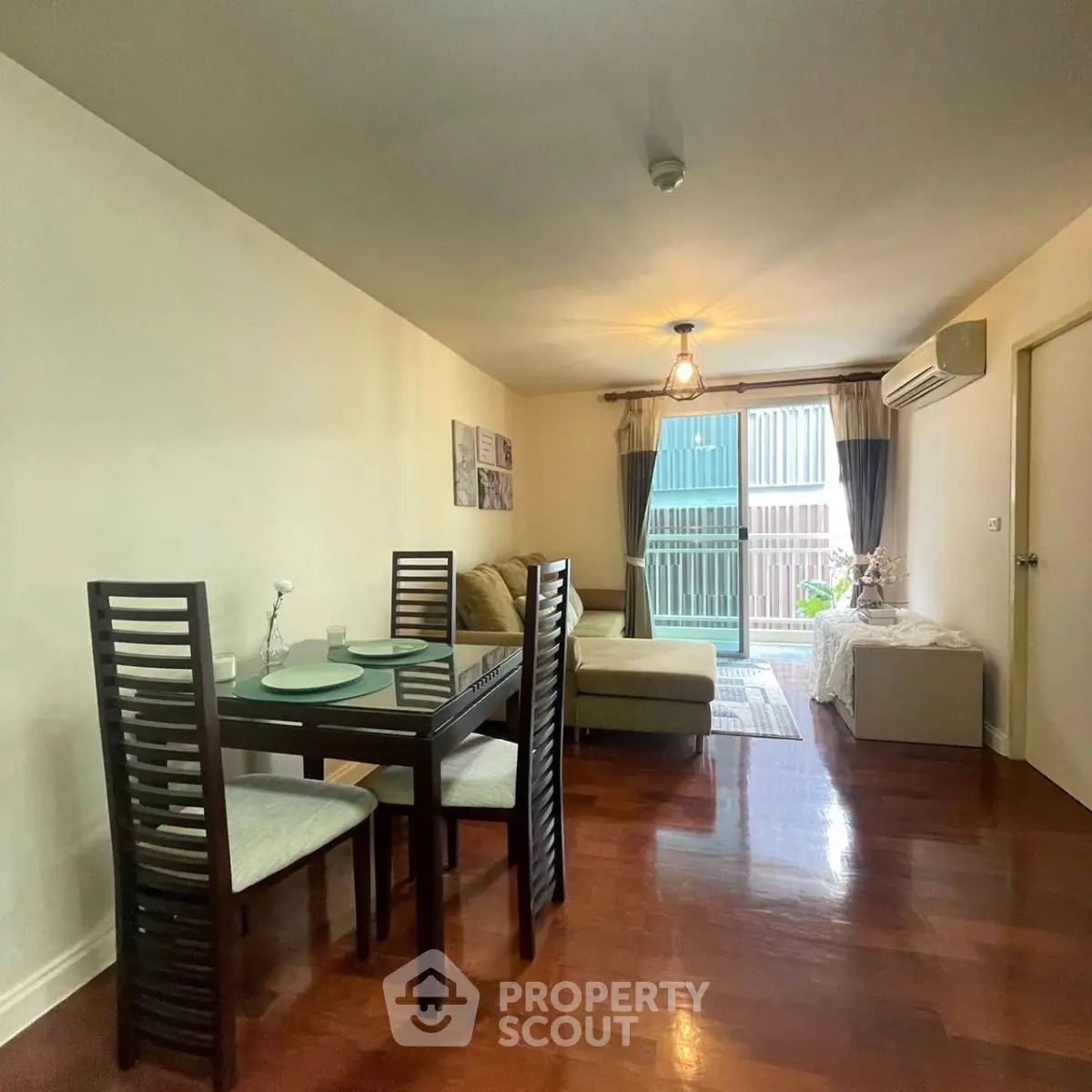 Spacious living room with elegant dining area and balcony access in modern apartment.