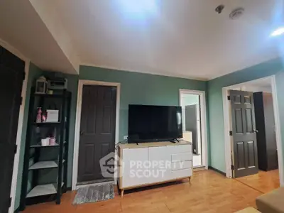 Spacious living room with modern TV setup and stylish shelving unit