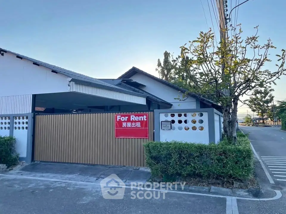 Charming house for rent with spacious driveway and lush greenery in a serene neighborhood.