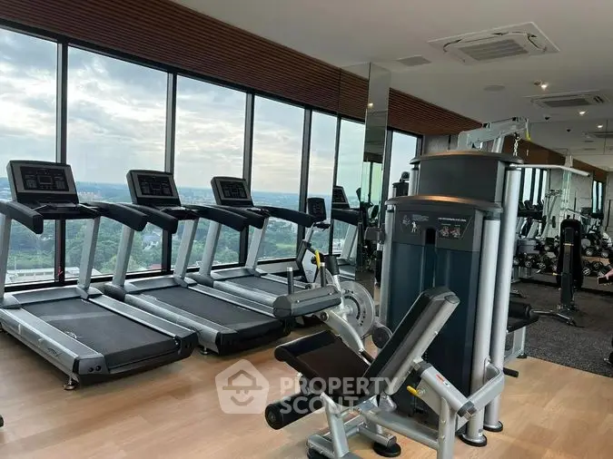 State-of-the-art fitness center with modern equipment and panoramic views, enhancing a luxurious lifestyle in a high-end property.