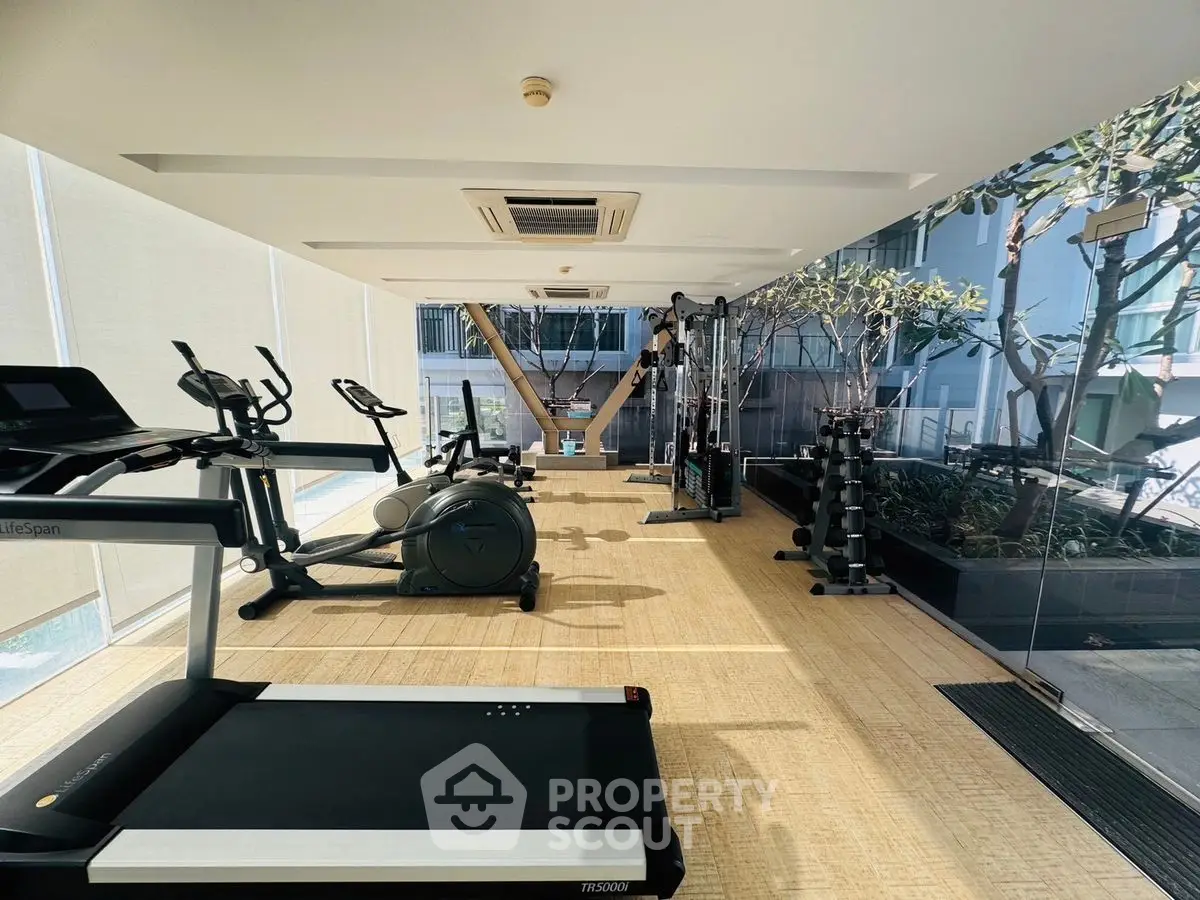 Modern gym with state-of-the-art equipment and floor-to-ceiling windows