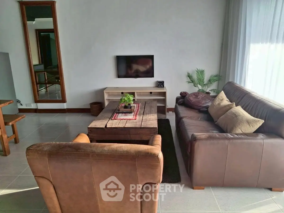 Cozy living room with leather sofa and rustic wooden coffee table