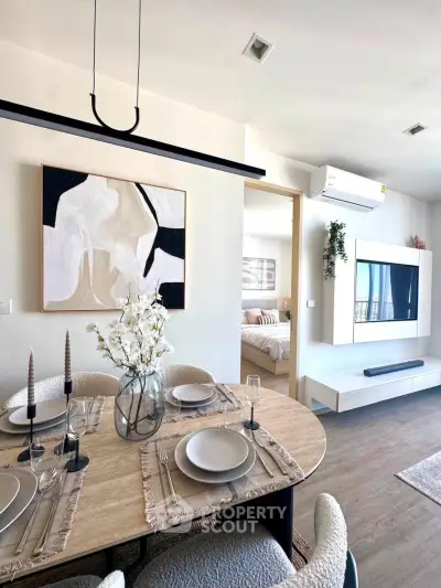 Modern open-plan living and dining area with stylish decor and natural light.