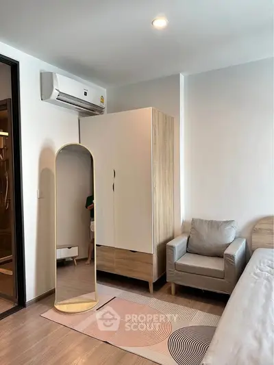 Modern bedroom with stylish furniture and air conditioning unit.