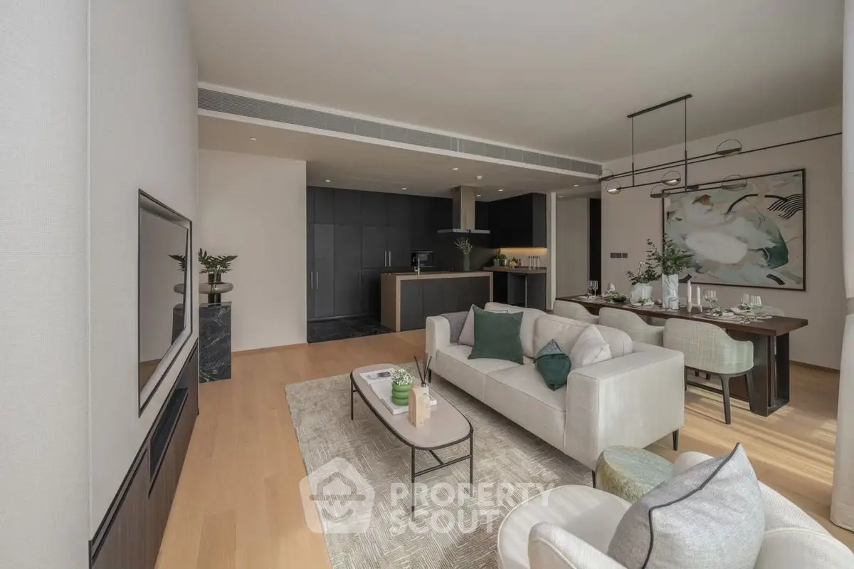 Spacious modern living room with open kitchen and elegant dining area, featuring stylish decor and ample natural light.