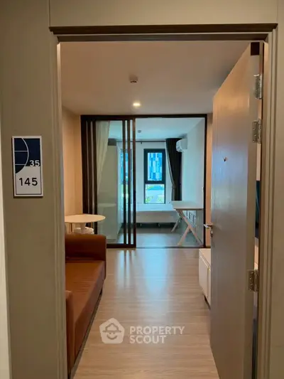 Modern apartment entrance with open living area and stylish decor