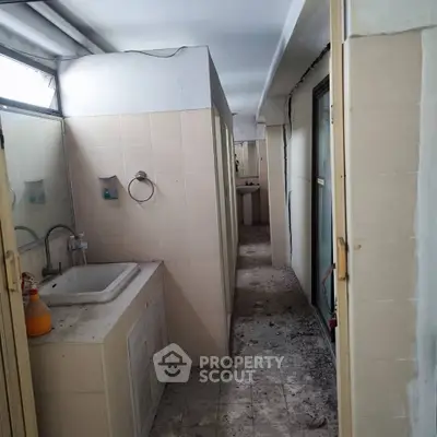 Spacious bathroom with dual sinks and ample natural light, ideal for renovation.