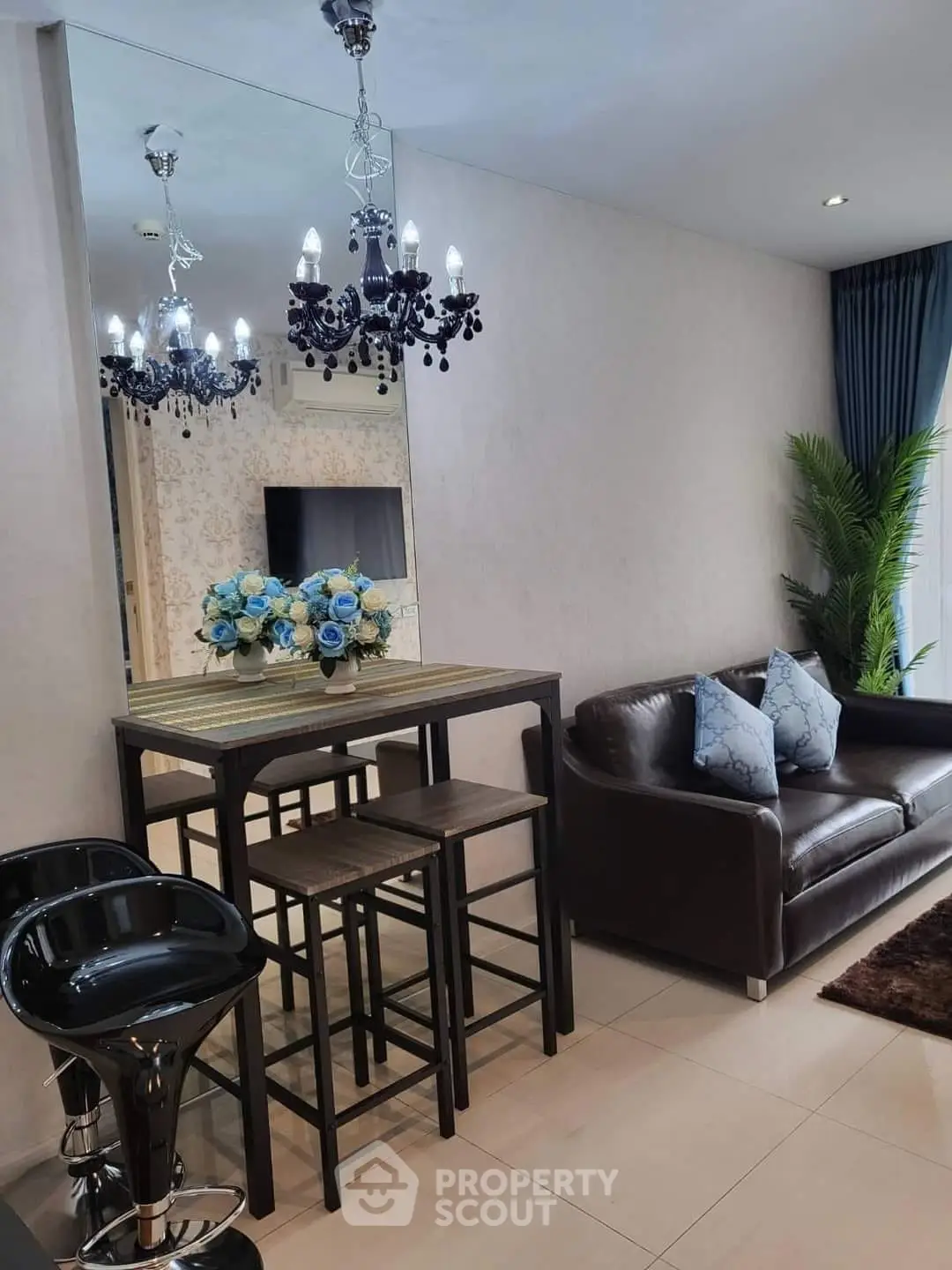 Stylish modern living room with elegant chandelier and cozy seating area