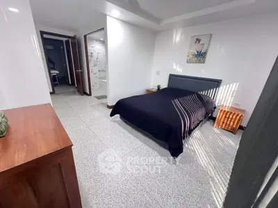 Spacious bedroom with modern decor and natural light