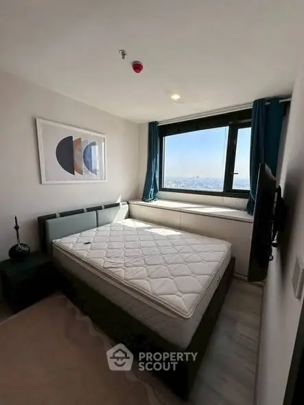 Modern bedroom with large window offering stunning city view