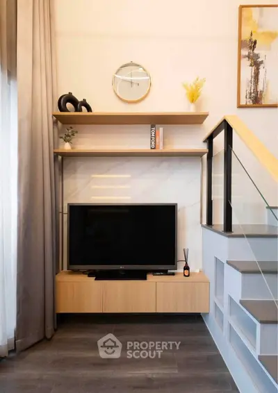 Modern living room with sleek TV setup and stylish shelving