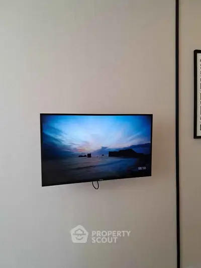 Modern wall-mounted TV in a stylish living room setting, perfect for entertainment and relaxation.