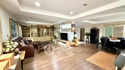 Spacious open-plan living room with elegant decor and ample natural light, perfect for family gatherings.
