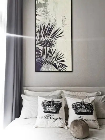 Stylish bedroom with elegant decor and crown-themed pillows