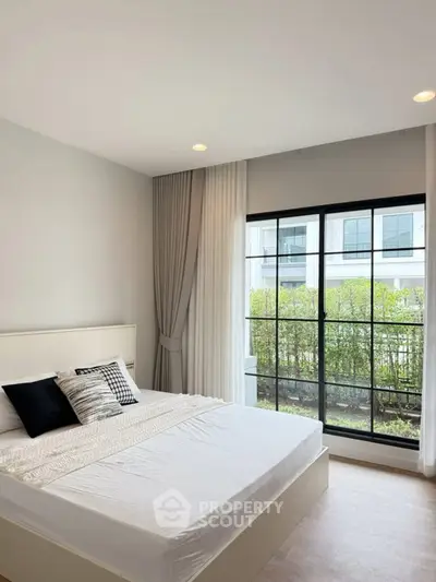 Modern bedroom with large window and stylish decor