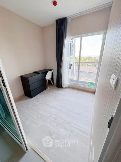 Bright and airy bedroom with large window and balcony access, perfect for natural light lovers.