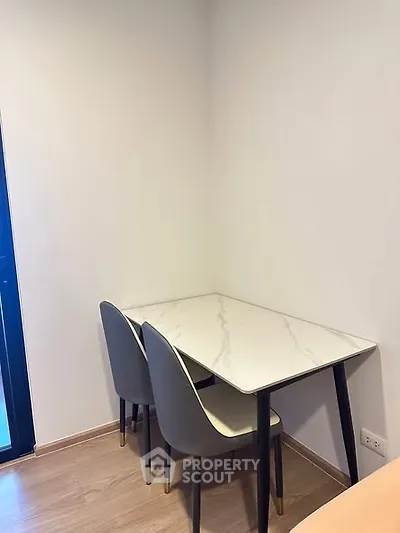 Modern minimalist dining area with marble table and sleek chairs