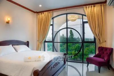 Luxurious bedroom with elegant decor and stunning large window view