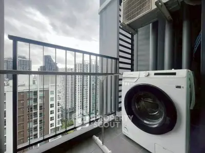 High-rise balcony with washing machine and city view, perfect for urban living.