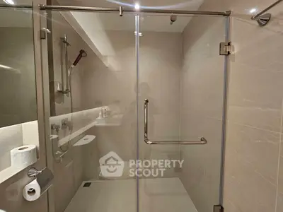 Modern bathroom with glass shower enclosure and sleek fixtures