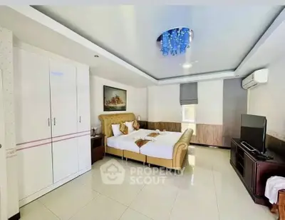Spacious bedroom with modern decor and elegant lighting in a luxury apartment.