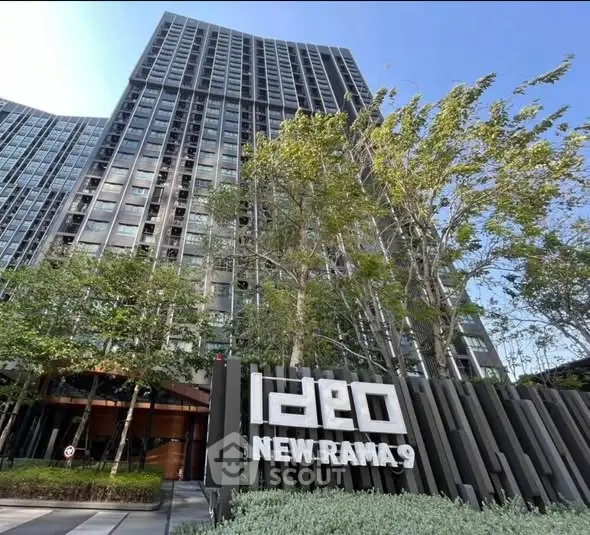 Modern high-rise building with lush greenery at Ideo New Rama 9.