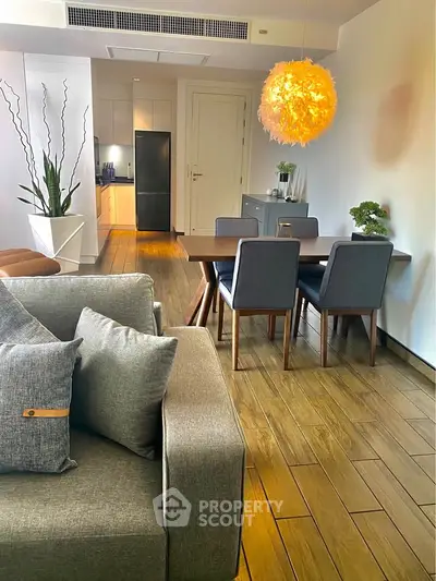 Stylish modern living room with elegant dining area and unique lighting fixture